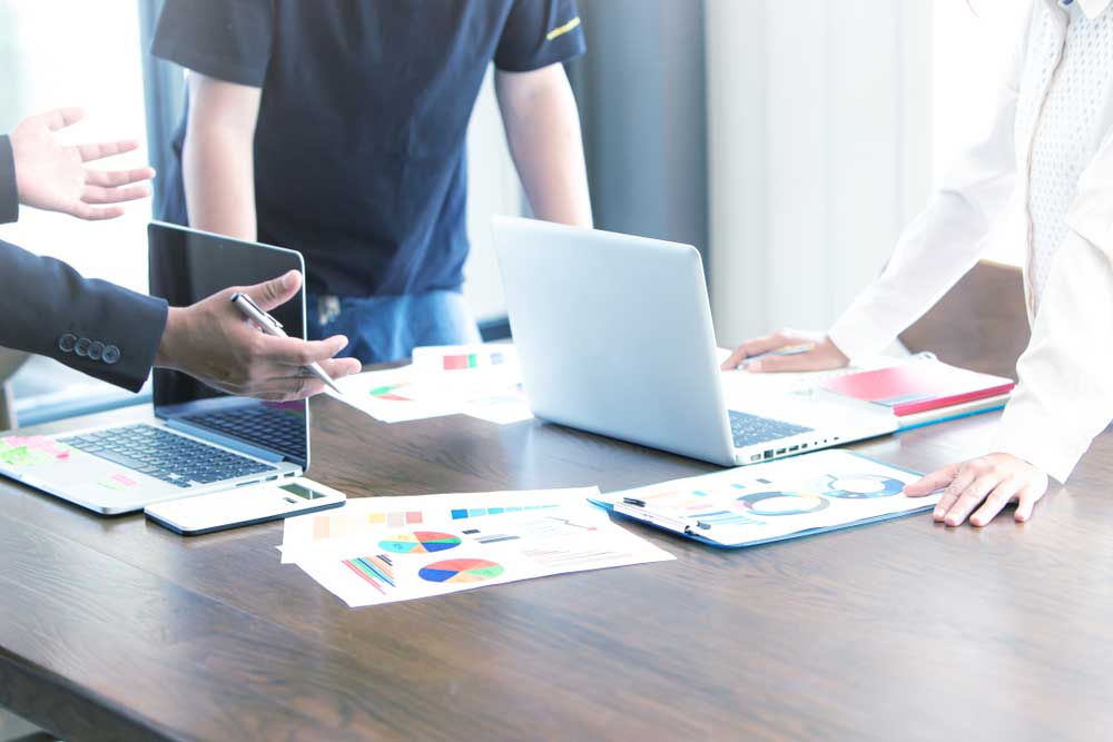 employees reviewing financial reports